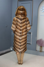 Load image into Gallery viewer, Full length muskrat fur hooded coat with racoon trim