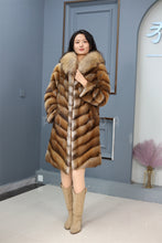 Load image into Gallery viewer, Full length muskrat fur hooded coat with racoon trim
