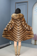 Load image into Gallery viewer, Full length muskrat fur hooded coat with racoon trim