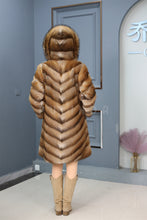 Load image into Gallery viewer, Full length muskrat fur hooded coat with racoon trim