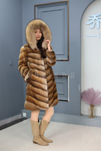 Load image into Gallery viewer, Full length muskrat fur hooded coat with racoon trim
