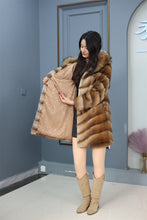Load image into Gallery viewer, Full length muskrat fur hooded coat with racoon trim